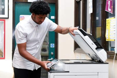 Work experience student at photocopier